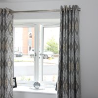 Eyelet headed curtains with matching roman blind, fitted